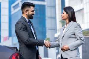 marketing executive giving a handshake to his client